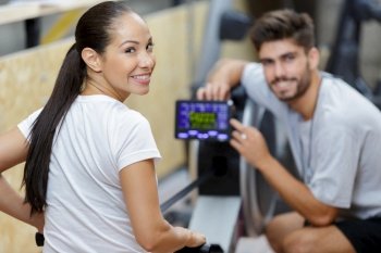 sporty girl working out on a rowing machine at gym