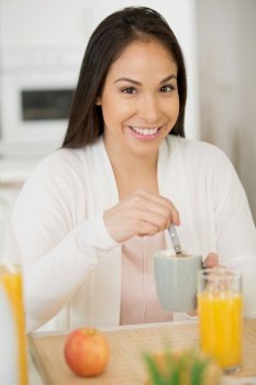 smiling pretty woman having healthy breakfast