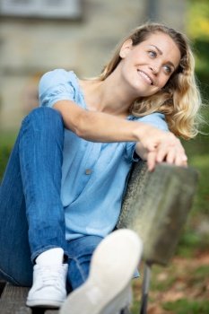 serene woman relaxing on park bench