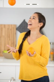 woman juggling with oranges