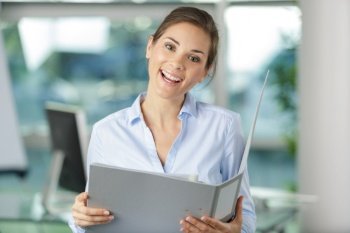 happy female office worker looking at camera