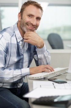 casual man working on computer in office