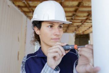 professional female worker using a screwdriver