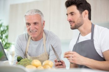 two men preparing vegetables in the home