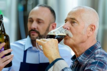 senior gentleman tasting craft beer