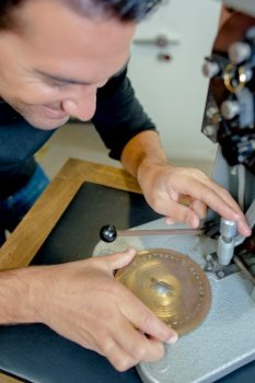 jeweler working on metals with optical device