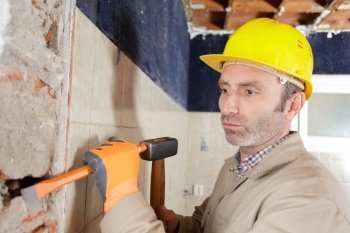 a construction worker with hammer and chisel