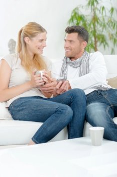Couple relaxing looking at mobile
