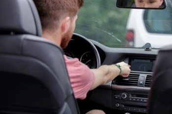 close-up of a man touching dashboard with finger