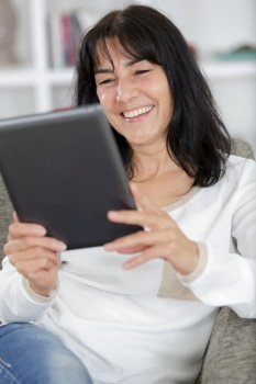 happy woman with tablet pc computer at home