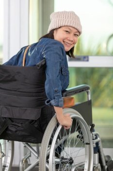 handicapped woman on wheelchair exiting a building