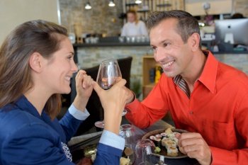 a couple toasting in restaurant