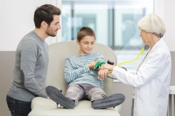 pediatrician with little boy checking blood pressure