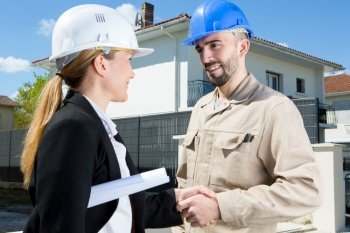 architect and contractor shaking hands