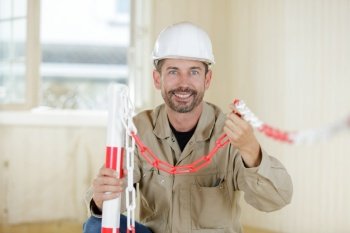 male builder setting up chains in site