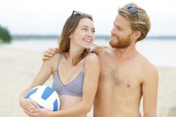 a beach volleyball couple outdoors