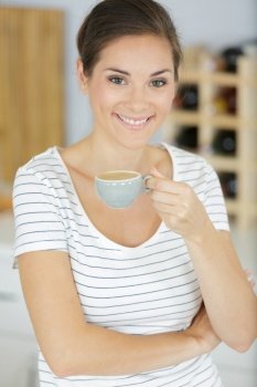 beautiful young woman drinking cofffee at home