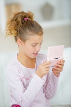 Young girl using a portable console