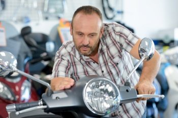 a man checks a motorbike