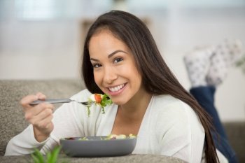 happy woman is eating salad