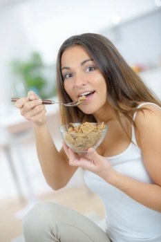 a woman is eating cereal