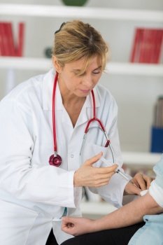 portrait of female doctor holding injection