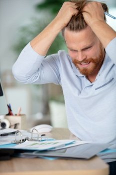 businessman stressed and overworked yelling in office