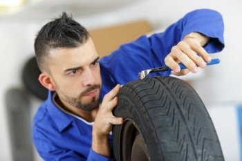 mechanic removing nail out of a tyre