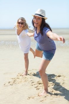smiling girls having fun on the beach