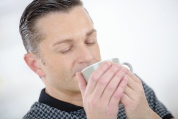 attractive middle-aged man enjoying a cup of coffee