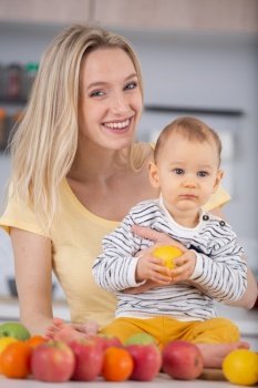 mother and baby in kitchen eating apple