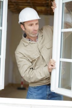 worker is installing a corner window