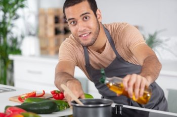 happy man cooking healthy food with recipe