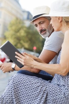 couple using a tablet outdoors