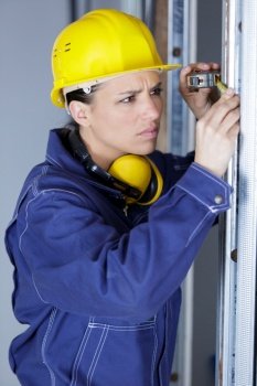 concentrated female builder measuring window