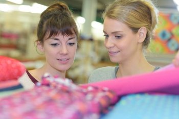 two women looking at fabric