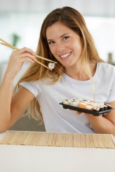 happy woman japanese traditional food sushi rolls