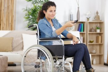 woman in wheelchair using remote control