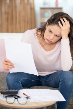 frustrated young woman looking through banking credit