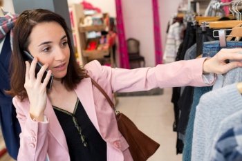 shopper looking at clothing indoors in store