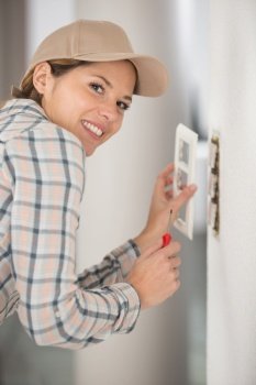 hvac technician installing a digital thermostat