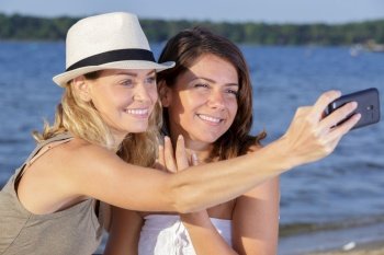 two woman doing a selfy in nature