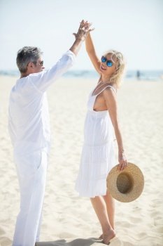 mature couple dancing on the beach happy and relax time