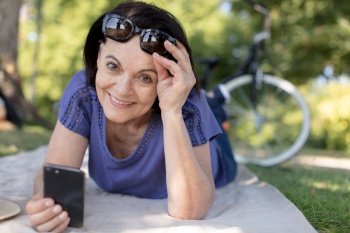 senior woman using smartphone in the park