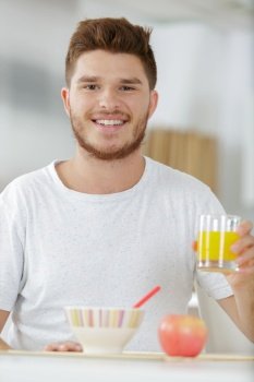 a happy young man having breakfast