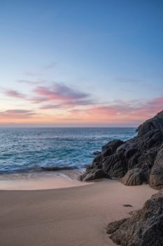Beautiful sunrise landscape at Porthcurno beach in Cornwall England with stunning colours and mood