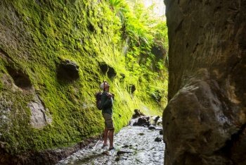 Hike in slot mossy canyon in Vancouver island, Canada