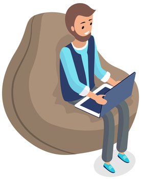 Man sitting in comfortable bag chair and browsing or working on laptop at his laps. Male character types on keyboard with computer, works remotely. Person is freelancing on laptop, online work. Man sitting in comfortable bag chair and browsing, freelancing or working on laptop at his laps