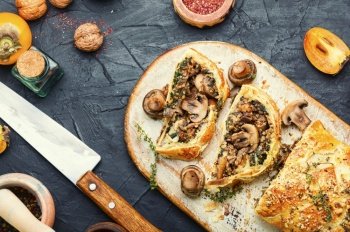 Closed homemade savory tart pie with mushrooms. Tasty autumn pie with mushrooms champignons.