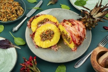 Baked pineapple stuffed with ground beef in bacon wrapped Chinese style. Pineapple fried with meat